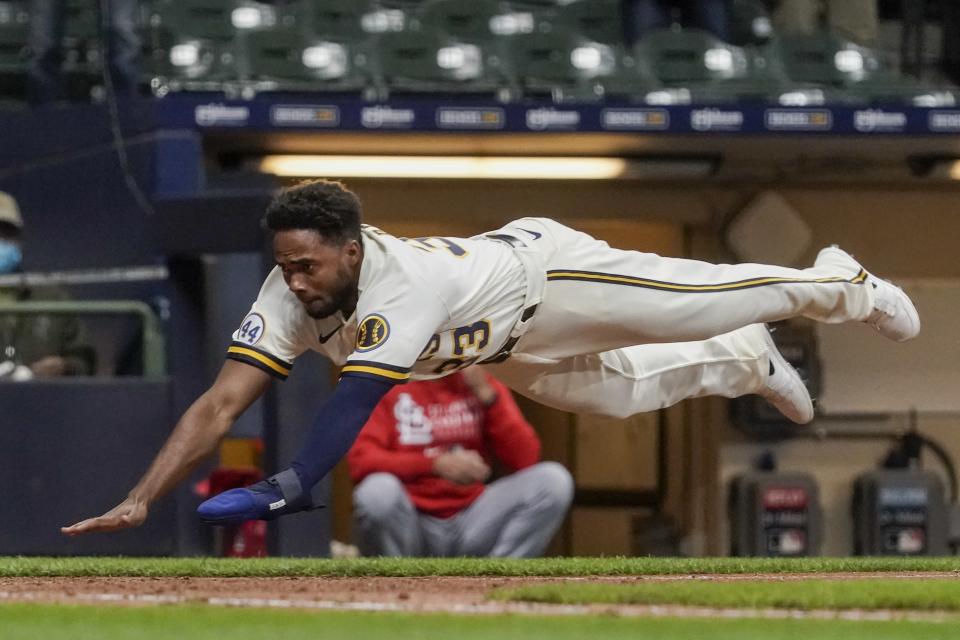 Milwaukee Brewers' Pablo Reyes scores during the eighth inning of a baseball game against the St. Louis Cardinals Wednesday, May 12, 2021, in Milwaukee. Reyes scored from first on a double by Travis Shaw. (AP Photo/Morry Gash)