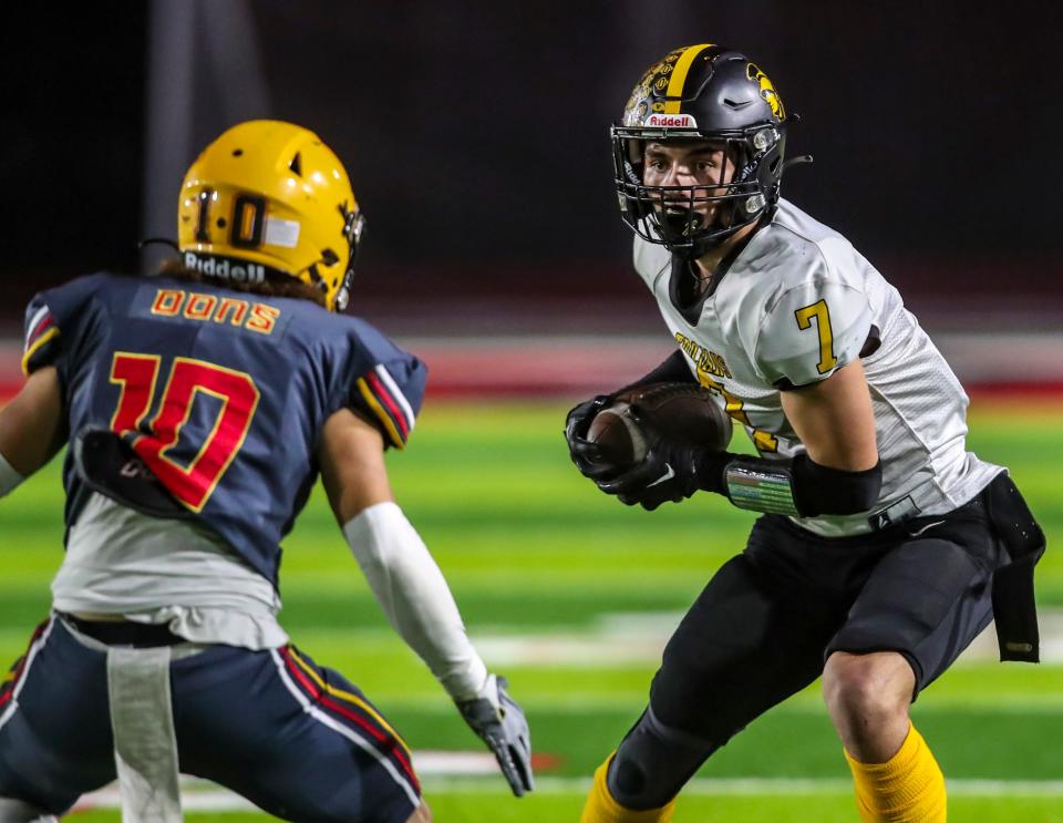 Yucca Valley's Javin Hudson (7) looks for room to run after a reception while facing Cerritos' Ruben Ligorria (10) during the second quarter of their CIF-SS Division 12 championship game at Artesia High School in Lakewood, Calif., Saturday, Nov. 25, 2023.