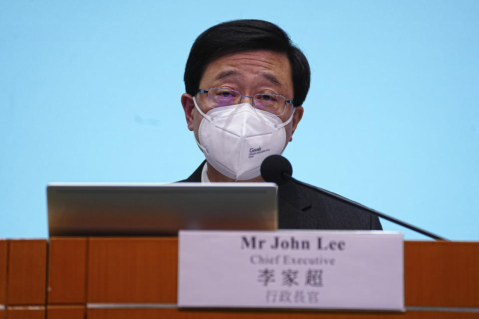 Hong Kong Chief Executive John Lee speaks during a news conference in Hong Kong, Friday, Sep. 23, 2022. Hong Kong's leader announced the city would no longer require incoming travelers to quarantine in designated hotels as the city seeks to open up globally after nearly two years. (AP Photo/Lam Yik)