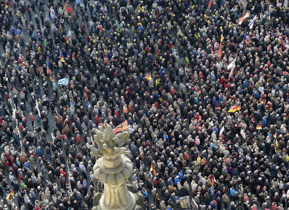 People take part in a rally of PEGIDA (Patriotic Europeans against the Islamization of the West) in Dresden, Germany, Sunday, Oct.21, 2018. (AP Photo/Jens Meyer)