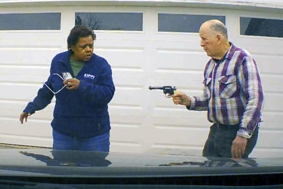 In this image taken from Uber dashcam video released by the Clark County, Ohio, Sheriff's Office, William Brock, right, holds a weapon to Uber driver Loletha Hall outside his home in South Charleston, Ohio, on March 25, 2024. Brock, 81, who authorities say fatally shot Hall who he thought was trying to rob him after scam phone calls deceived them both, was indicted on a murder charge, Monday, April 15, 2024, by a Clark County grand jury. Hall had no knowledge of the calls made to Brock, authorities said. (Clark County Sheriff's Office via AP)