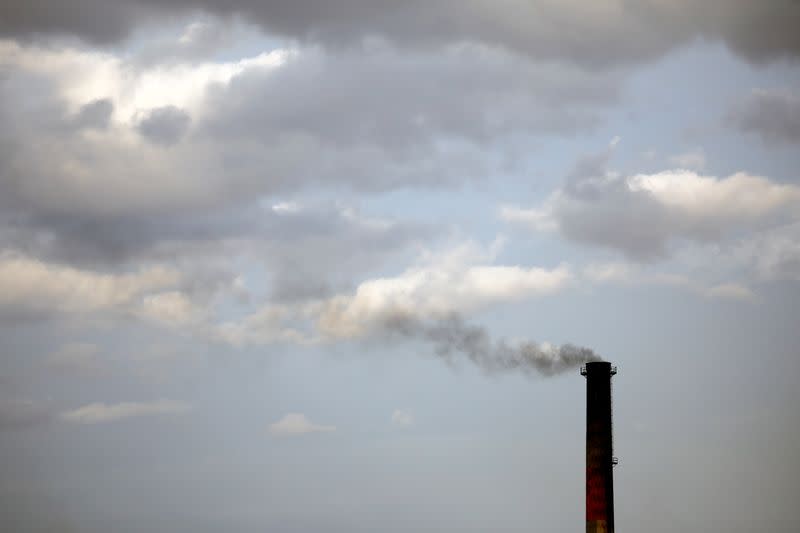 FILE PHOTO: Smoke rises from a coke factory in the village of Lukavac near Tuzla