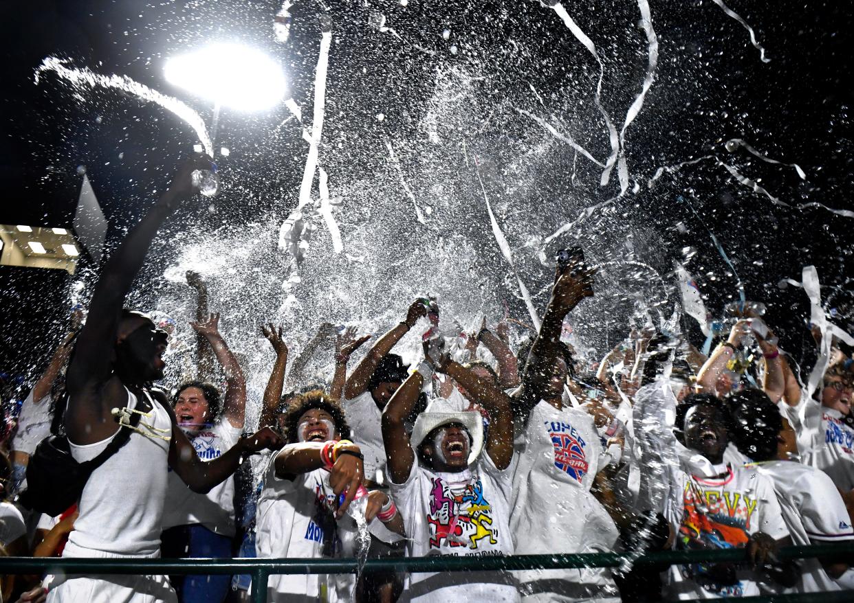 Cooper High students on the home side of Friday’s crosstown showdown against Abilene High throw ribbons and fling water into the air during a third quarter show of school spirit at Shotwell Stadium Sept. 1.