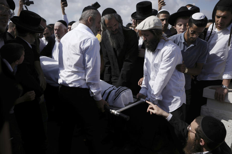 Yonatan Havakuk is buried in Petah Tikva, Israel, the day after he was killed with two others in a stabbing attack in Elad, Friday, May 6, 2022. Israeli security forces waged a massive manhunt Friday for two Palestinians suspected of carrying out the stabbing attack on Thursday near Tel Aviv that left three Israelis dead.(AP Photo/Ariel Schalit)