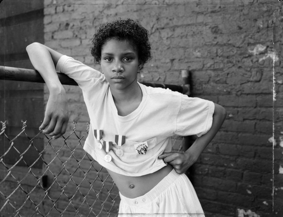 <p>Another standout from the Sean Kelly booth was this 1988 portrait by American photographer Dawoud Bey. Though Bey’s most recent work has drifted into more conceptual territory, his early street photography captured everyday life in Black communities. <em>A Girl with School Medals</em> depicts a young teenager, but her jaunty posture and direct gaze suggest wisdom beyond her years. Missed this photo at Frieze? Check out Bey’s <a href="https://whitney.org/exhibitions/dawoud-bey" rel="nofollow noopener" target="_blank" data-ylk="slk:show;elm:context_link;itc:0;sec:content-canvas" class="link ">show</a> at the Whitney Museum of American Art, on view through October 3.</p>