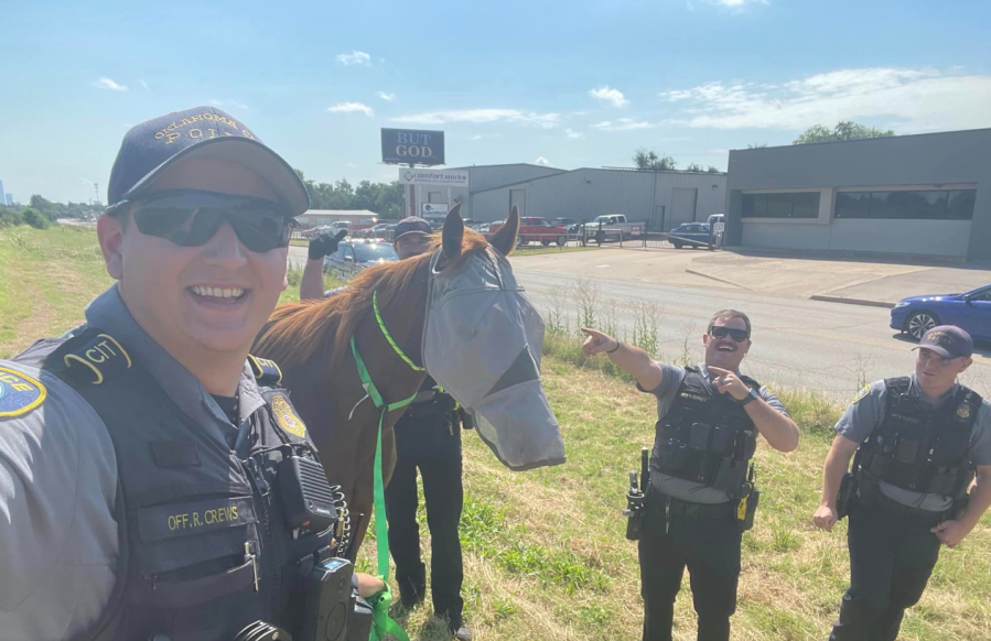 Four Oklahoma City police officers with runaway horse.