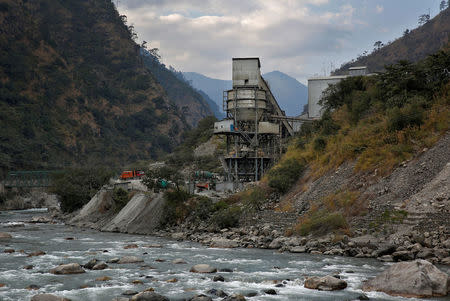 The Punatsangchu River runs past an industrial site located near the town of Wangdue Phodrang, Bhutan, December 13, 2017. REUTERS/Cathal McNaughton