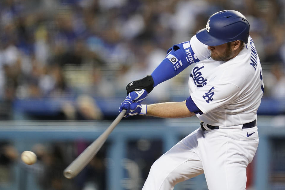 Los Angeles Dodgers' Max Muncy (13) singles during the first inning of a baseball game against the Cincinnati Reds in Los Angeles, Thursday, April 14, 2022. Trea Turner scored. (AP Photo/Ashley Landis)