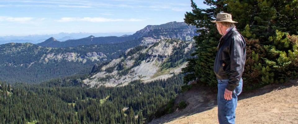 Retired senior man looking at view in Mt. Rainier National park Washington State USA