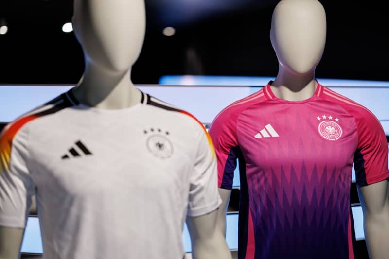 The official jerseys of the German national soccer team for the upcoming European Football Championship 2024 (UEFA EURO 2024) are seen at the headquarters of sporting goods manufacturer Adidas AG. Daniel Karmann/dpa