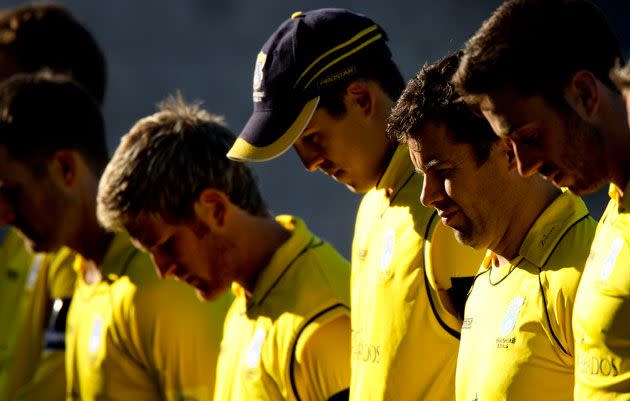 Hampshire players wear black armbands as they observe a minute's silence in memory of Tom Maynard. Photo: Getty Images