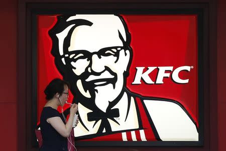 A customer walks past a KFC store in Shanghai July 22, 2014. The latest food scandal in China is spreading fast, dragging in U.S. coffee chain Starbucks, Burger King Worldwide Inc and others, as well as McDonald's products as far away as Japan. REUTERS/Aly Song