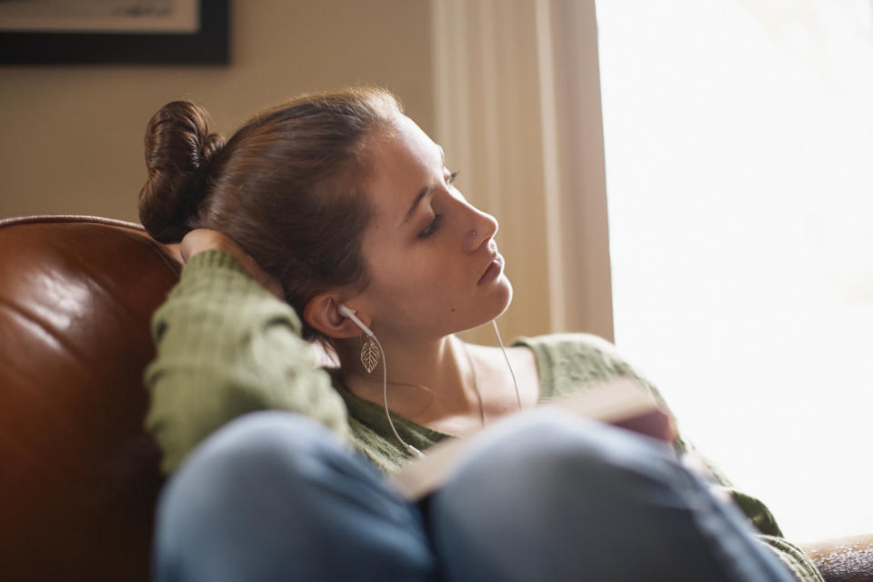 A girl listening to music on her headphones