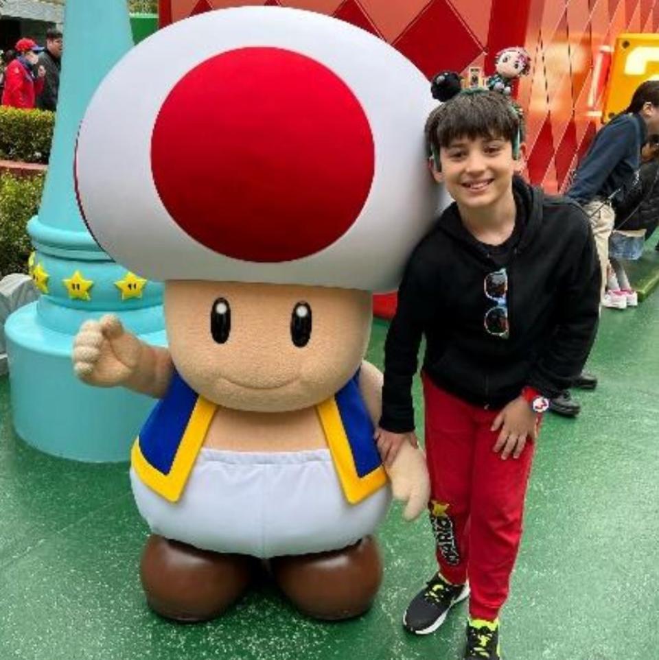 boy posing with toad at universal japan