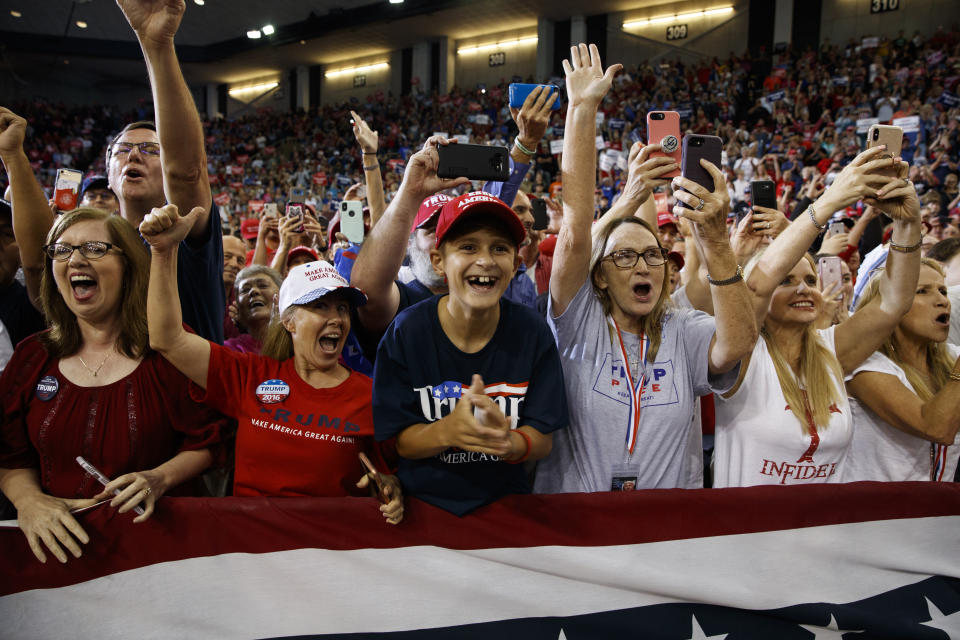 Supporters of President Donald Trump cheer as he arrives to speak during a campaign rally at the Lake Charles Civic Center, Friday, Oct. 11, 2019, in Lake Charles, La. (AP Photo/Evan Vucci)