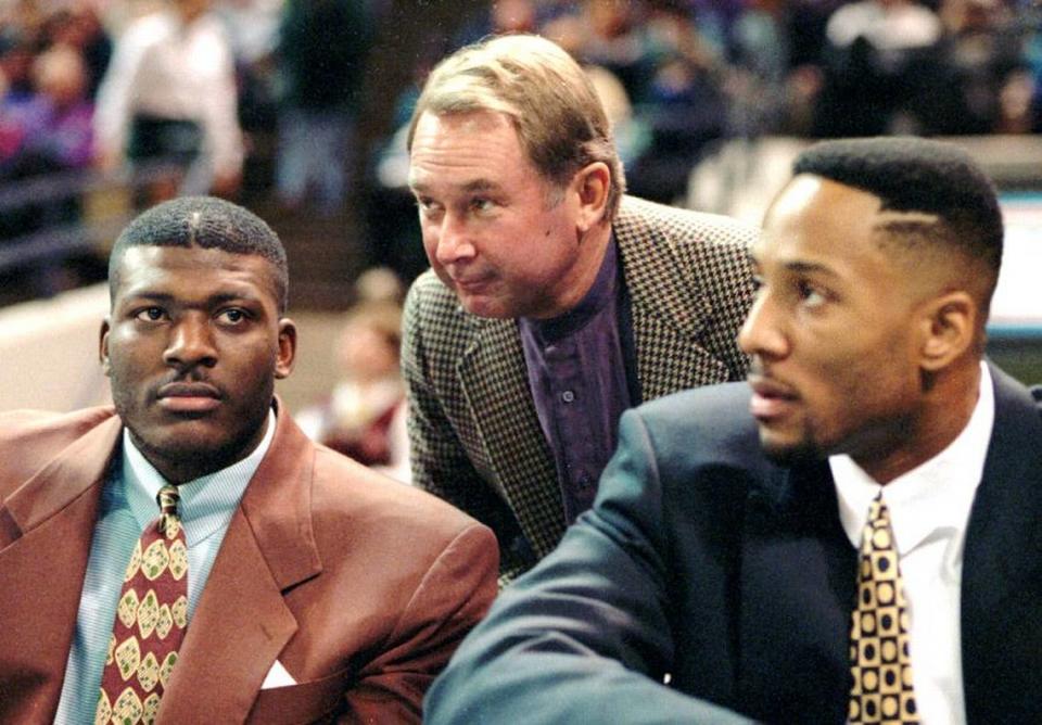 In early 1994, Hornets owner George Shinn (center) visited with Larry Johnson (left) and Alonzo Mourning. After paying Johnson what was then the largest contract in NBA history, Shinn and the Hornets traded Mourning in November 1995.