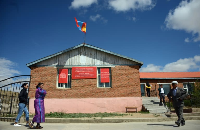 Villagers enter a polling station after voting in parliamentary elections in Mandalgovi, in Mongolia's middle Gobi province on June 29, 2016