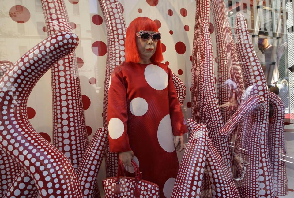 A wax model of Japanese artist Yayoi Kusama is displayed in the windows of Louis Vuitton's flagship Fifth Avenue store in New York, Tuesday, July 10, 2012, part of a collaborative collection by Kusama and Vuitton creative director Marc Jacobs, shown after they were unveiled Tuesday. (AP Photo/Kathy Willens)