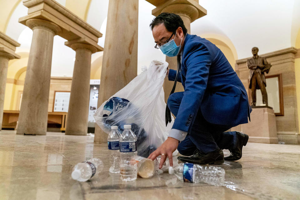 Rep. Andy Kim, DN.J., clears debris and trash (Andrew Harnik/AP)