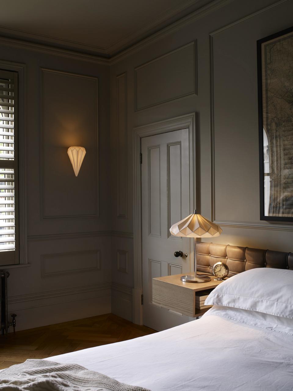 bedroom in dark grey walls and red light bulbs