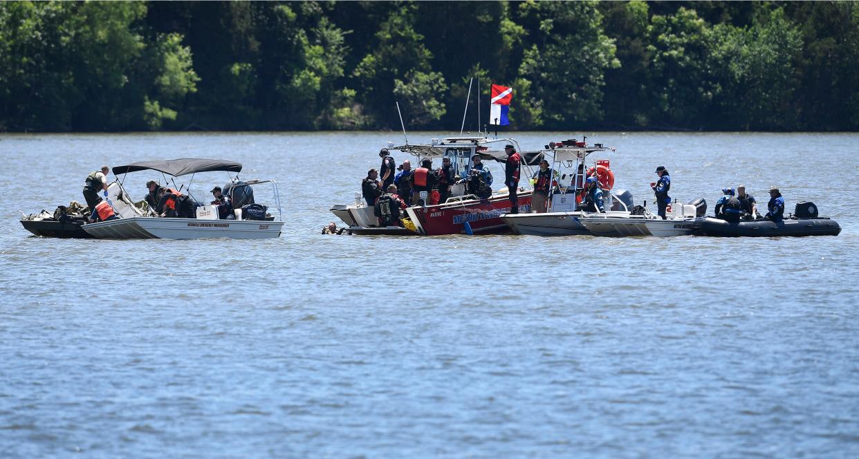 <p>Emergency personnel remove debris from a plane crash in Percy Priest Lake Sunday, 30 May, 2021, near Smyrna, Tennessee. A small jet carrying seven people crashed Saturday, and authorities indicated that no one on board survived</p> (AP)