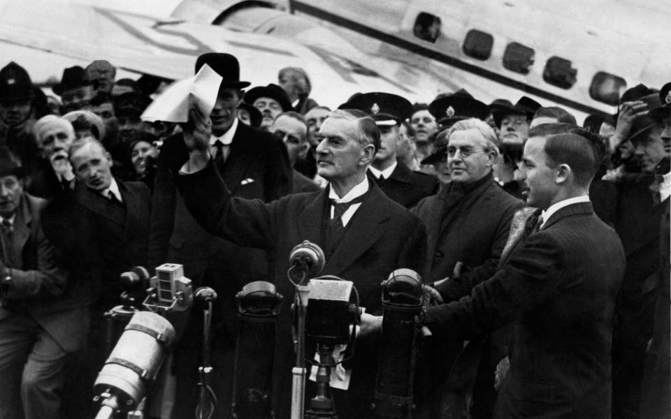 Neville Chamberlain at Heston Airport after returning from his summit meeting with Adolf Hitler in Munich - Mirrorpix