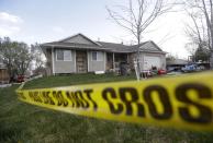 Pleasant Grove Police investigate the scene where seven infant bodies were discovered and packaged in separate containers at a home in Pleasant Grove, Utah, Sunday, April 13, 2014. According to the Pleasant Grove Police Department, seven dead infants were found in the former home of Megan Huntsman, 39. Huntsman was booked into jail on six counts of murder. (AP Photo/Rick Bowmer)