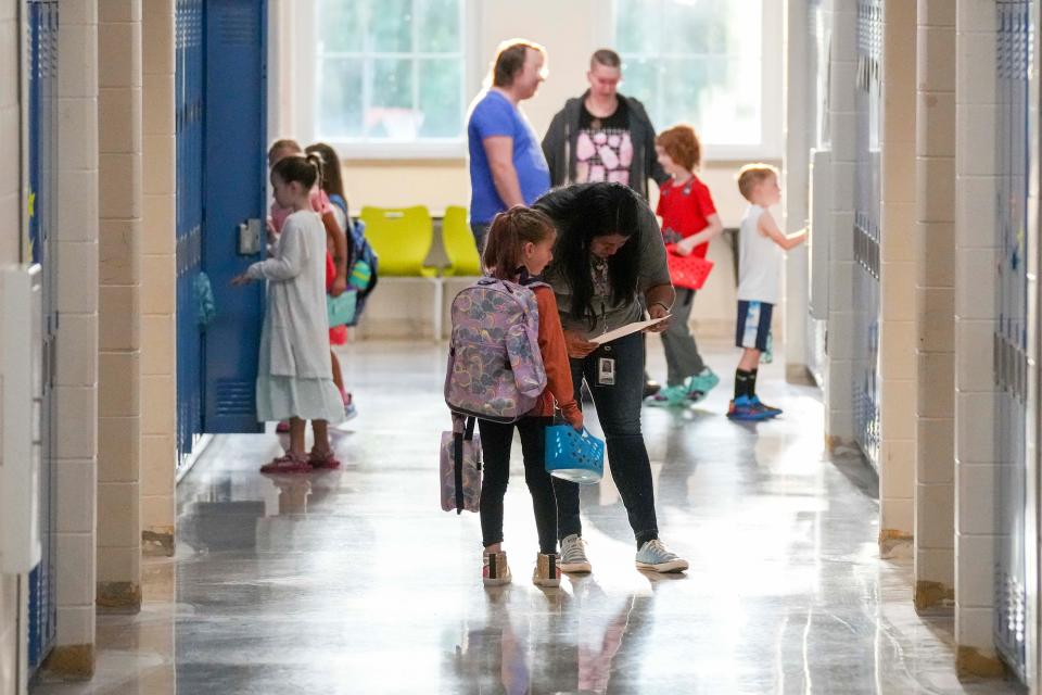 Parents, teachers, and students learn their lockers and find information about their classrooms before the first day of school at Perkins Elementary Wednesday, Aug. 24, 2022 in Des Moines. 