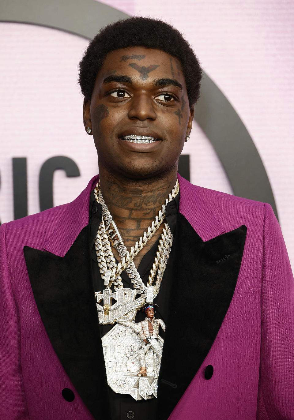 Kodak Black Wearing A Purple And Black Suit