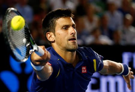 Serbia's Novak Djokovic hits a shot during his semi-final match against Switzerland's Roger Federer at the Australian Open tennis tournament at Melbourne Park, Australia, January 28, 2016. REUTERS/Thomas Peter