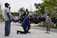 Democratic presidential candidate former Vice President Joe Biden visits with C.J. Brown, right, and Clement Brown, the son and father of the owner of Three Thirteen, as Biden arrives to shop for his grandchildren at the store in Detroit, Wednesday, Sept. 9, 2020. Biden is visiting Michigan for campaign events. (AP Photo/Patrick Semansky)