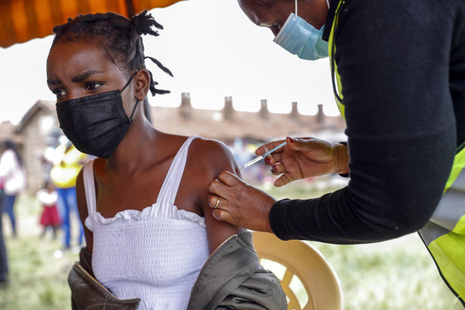 A Kenyan woman receives a dose of AstraZeneca coronavirus vaccine donated by Britain, at the Makongeni Estate in Nairobi, Kenya Saturday, Aug. 14, 2021. In late June, the international system for sharing coronavirus vaccines sent about 530,000 doses to Britain – more than double the amount sent that month to the entire continent of Africa. It was the latest example of how a system that was supposed to guarantee low and middle-income countries vaccines is failing, leaving them at the mercy of haphazard donations from rich countries. (AP Photo/Brian Inganga)