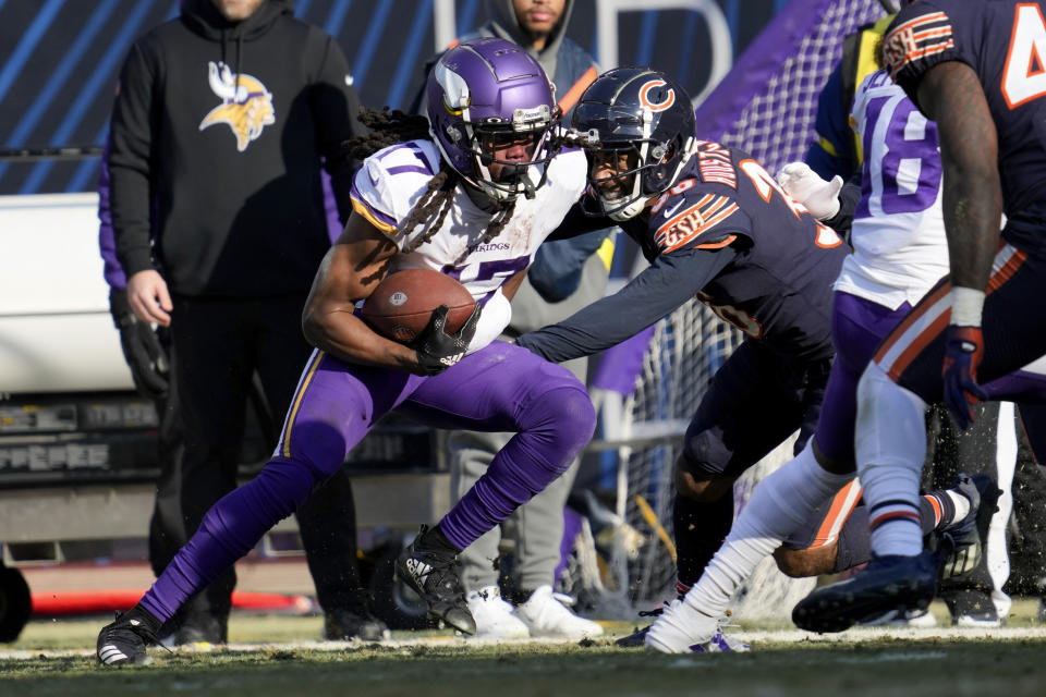 Minnesota Vikings wide receiver K.J. Osborn (17) runs from Chicago Bears safety DeAndre Houston-Carson (36) after catching a pass during the first half of an NFL football game, Sunday, Jan. 8, 2023, in Chicago. (AP Photo/Nam Y. Huh)