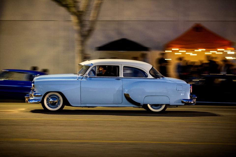 A classic car parades down Van Nuys