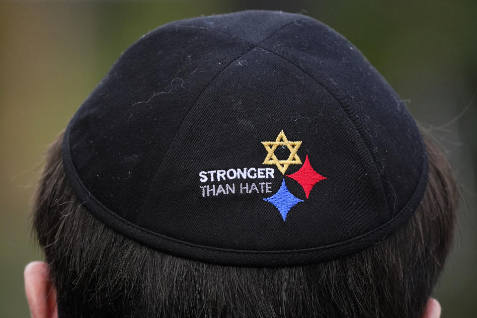 FILE - In this Oct. 27, 2020 file photo, Aaron Myers attends a moment of remembrance outside the Tree of Life synagogue in Pittsburgh, the second year since the shooting at the synagogue, that killed 11 worshippers. As the three-year mark since the massacre at the Tree of Life synagogue approaches, survivors are planning now-familiar annual rituals of remembrance, the criminal case involving the suspect plods on and the massacre site is in line for restoration. (AP Photo/Gene J. Puskar, File)