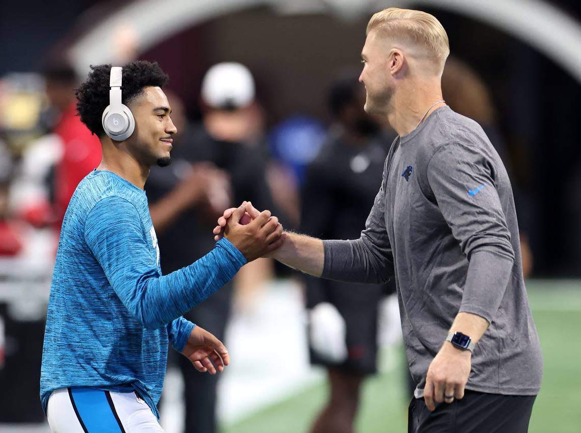 Carolina Panthers rookie quarterback Bryce Young, left and quarterbacks coach Josh McCown, right, shake hands at Mercedes-Benz Stadium in Atlanta, GA on Sunday, September 10, 2023. Young and the Panthers open the NFL season against the Atlanta Falcons.