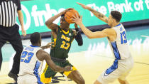 North Dakota State's Maleeck Harden-Hayes, center, looks to pass under coverage from Creighton's Damien Jefferson, left, and Christian Bishop during the first half of an NCAA college basketball game in Omaha, Neb., Sunday, Nov. 29, 2020. (AP Photo/Kayla Wolf)