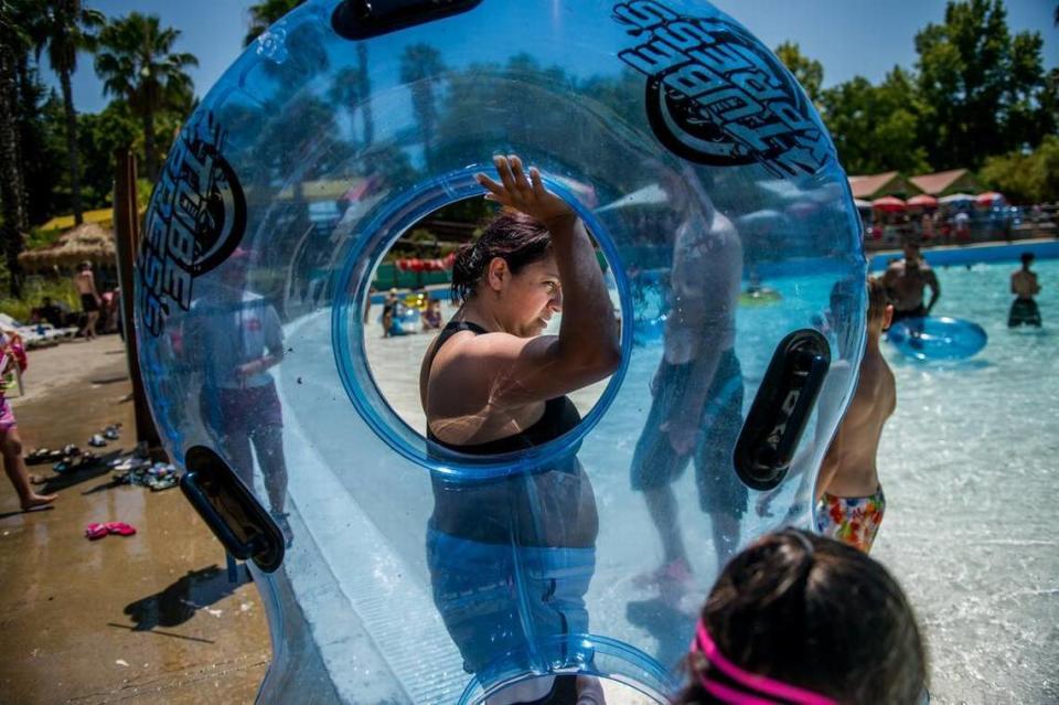 A woman heads to the wave pool at Raging Waters.