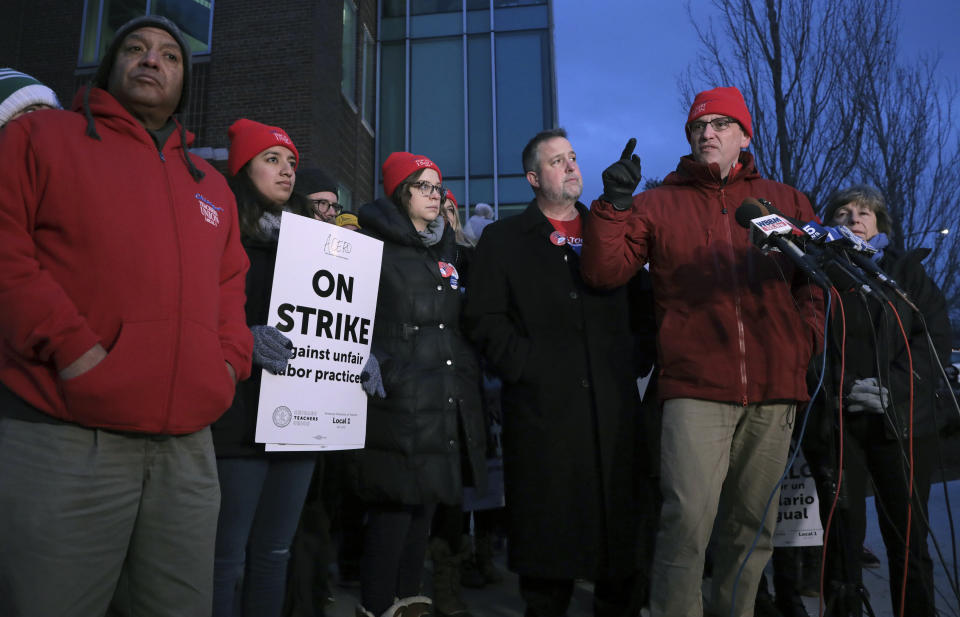 President of the Chicago Teachers Union Jesse Sharkey talks with members of the media as charter school teachers and their supporters walk the picket line outside the Acero's Zizumbo Elementary Charter school, Tuesday, Dec. 4, 2018. Hundreds of teachers have gone on strike at the Chicago charter school network, leading to canceled classes for thousands of students. (Antonio Perez/Chicago Tribune via AP)