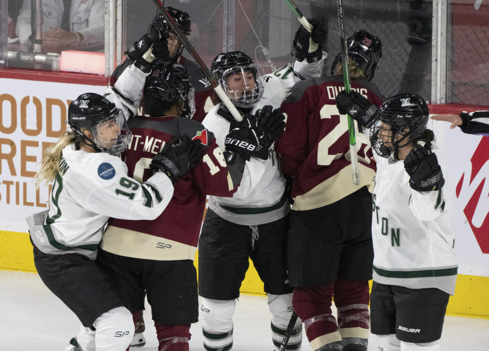 Boston's Amanda Pelkey, right, celebrates after her goal over Montreal with teammates during first-period PWHL playoff hockey game action in Laval, Quebec, Saturday, May 11, 2024. (Christinne Muschi/The Canadian Press via AP)