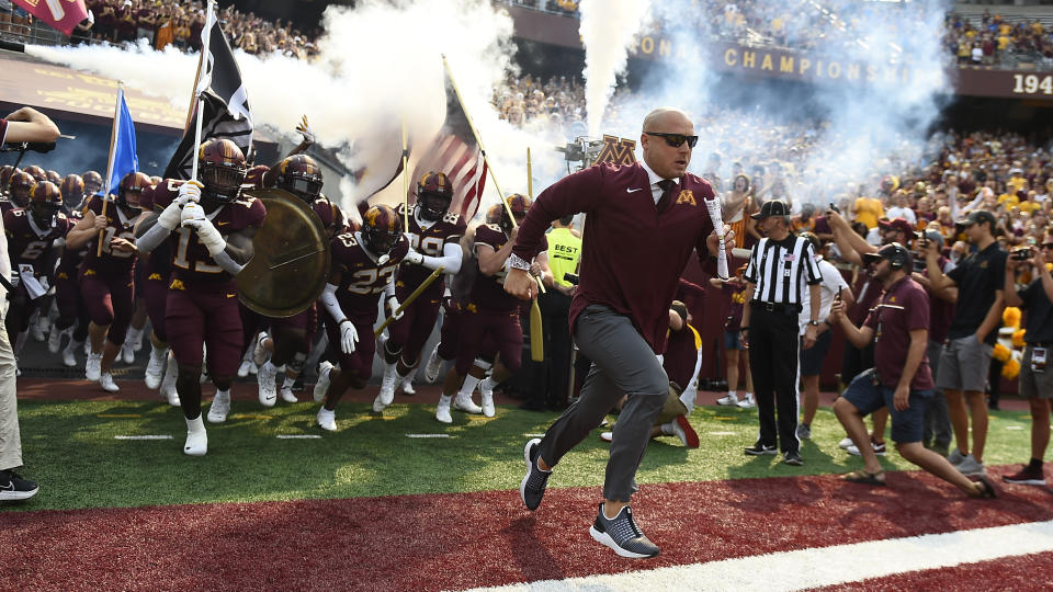 Minnesota head coach P.J. Fleck runs onto the field before their game against Miami-Ohio during an NCAA college football game on Saturday, Sept. 11, 2021, in Minneapolis. Minnesota won 31-26. (AP Photo/Craig Lassig)