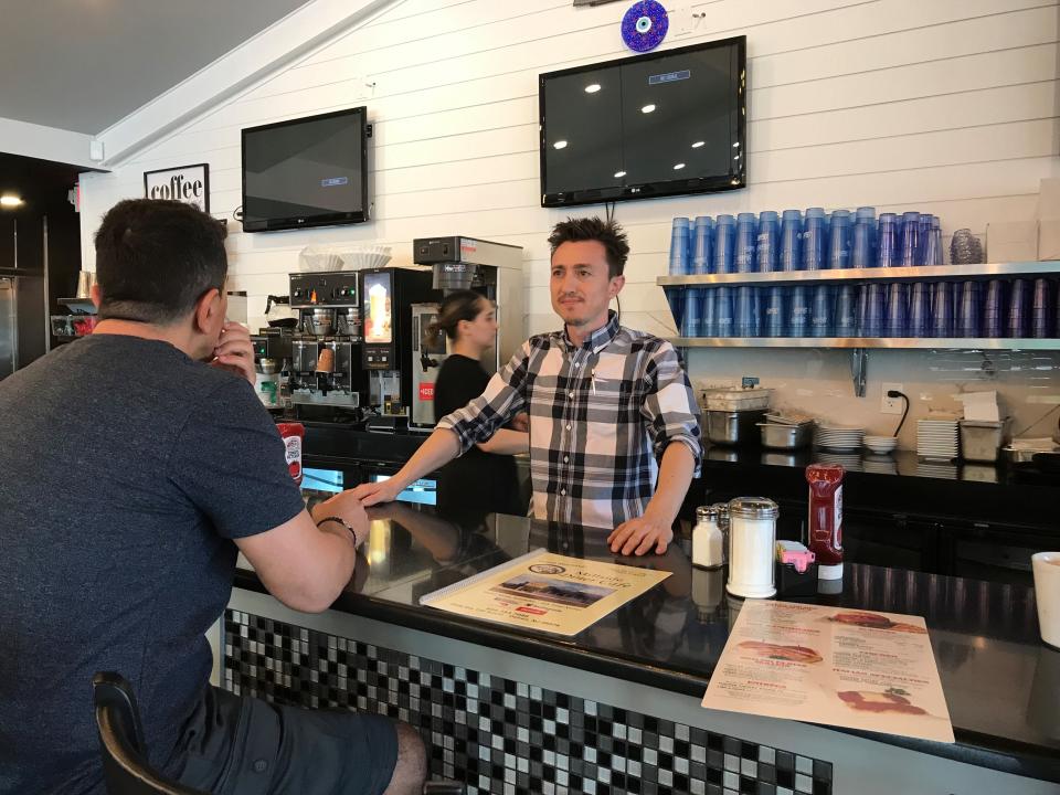 Millside Diner and Cafe co-owner Ufuk Zaragoz, converses with a counter customer at the newly opened restaurant at 2929 Route 130 South in Delran on May 22, 2023. The diner has an optional menu conforming to Islamic food preparation requirements known as Halal.