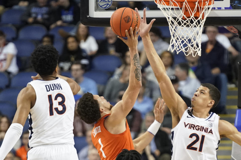 Clemson guard Chase Hunter (1) shoots against Virginia forward Kadin Shedrick (21) and guard Ryan Dunn (13) during the first half of an NCAA college basketball game at the Atlantic Coast Conference Tournament in Greensboro, N.C., Friday, March 10, 2023. (AP Photo/Chuck Burton)