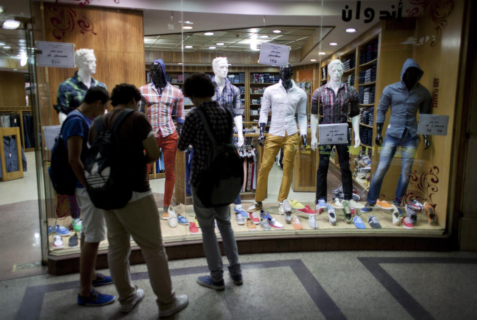 Egyptian men shop inside a commercial mall in Cairo, Egypt, Wednesday, Oct. 31, 2012. Egypt’s capital prides itself on being city that never sleeps, with crowds filling cafes and shops open into the small hours. So the government is facing a backlash from businesses and the public as it vows to impose new nationwide rules closing stores and restaurants early. Officials say the crisis-ridden nation has to conserve electricity, but they also seem intent on taming a population they see as too unruly. (AP Photo/Nasser Nasser)