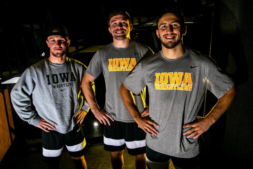 Iowa 149-pound wrestler Max Murin, left, poses for a photo with teammates 197-pound wrestler Jacob Warner, center, and 174-pound wrestler Michael Kemerer during Hawkeyes men's wrestling media day, Wednesday, Oct. 27, 2021, at Carver-Hawkeye Arena in Iowa City, Iowa.