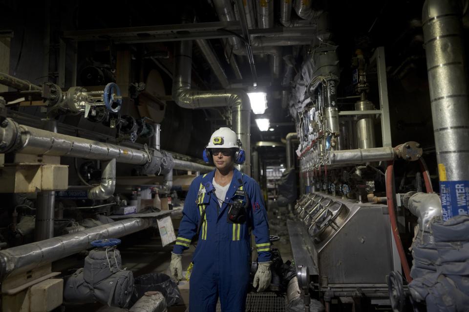 A worker poses for a photo at Cenovus' Sunrise oil facility northeast of Fort McMurray on Thursday, Aug. 31, 2023. (AP Photo/Victor R. Caivano)