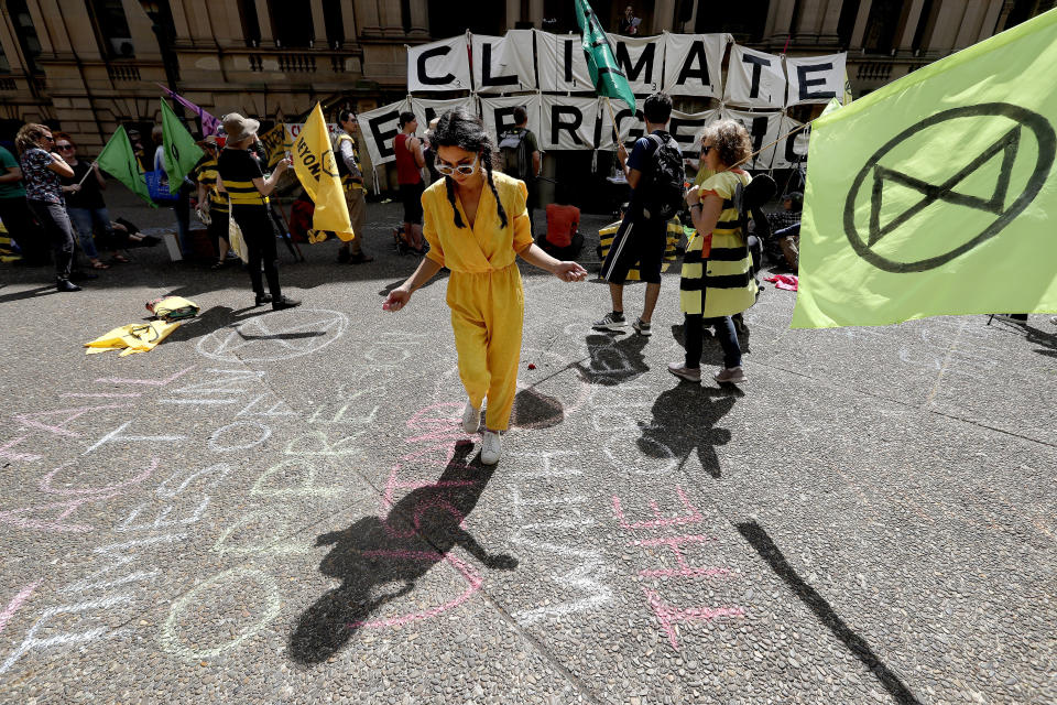 Climate change protestors from the Extinction Rebellion movement gather to demonstrate at Town Hall in Sydney, Tuesday, Oct. 8, 2019. In a series of protests also including Australian cities of Melbourne, Brisbane and Perth, protestors are demanding much more urgent action against climate change. (AP Photo/Rick Rycroft)