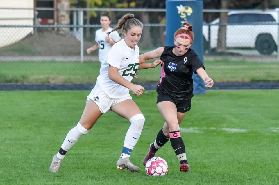 Rice's Megan Marroquin battles with Milton's Holley MacLellan during the Green Knights' 6-5 overtime win over the Yellowjackets on Tuesday evening in Milton