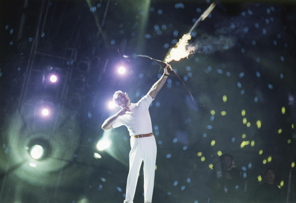 An arrow carrying the Olympic flame leaves the bow of Antonio Rebollo to light the Olympic Torch and open the XXV Olympic in Barcelona Saturday night, July 25, 1992. (AP Photo/ Dominique Mollard)