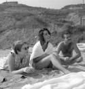 <p>Here, a candid photo shows Elizabeth enjoying a day at the beach with friends. </p>